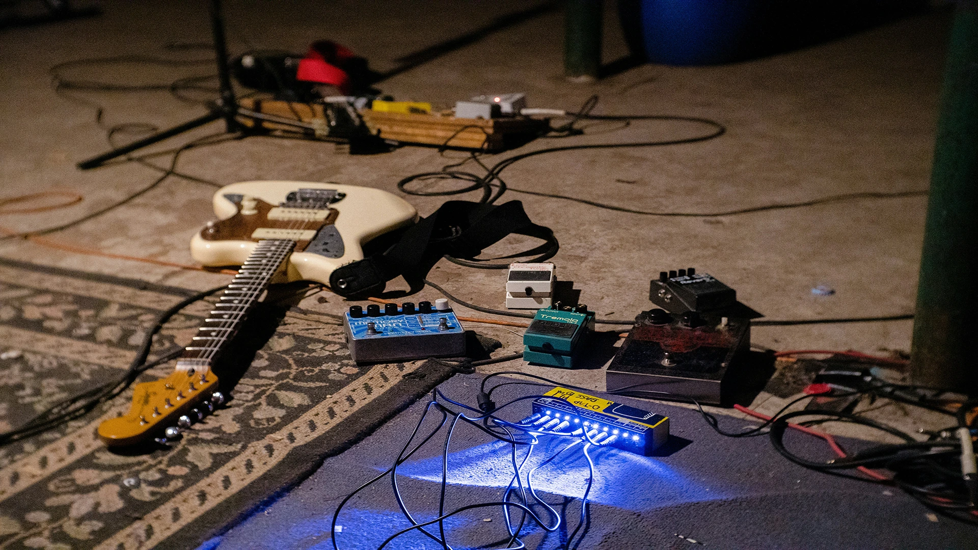 Collection of guitar pedals arranged on a reflective surface